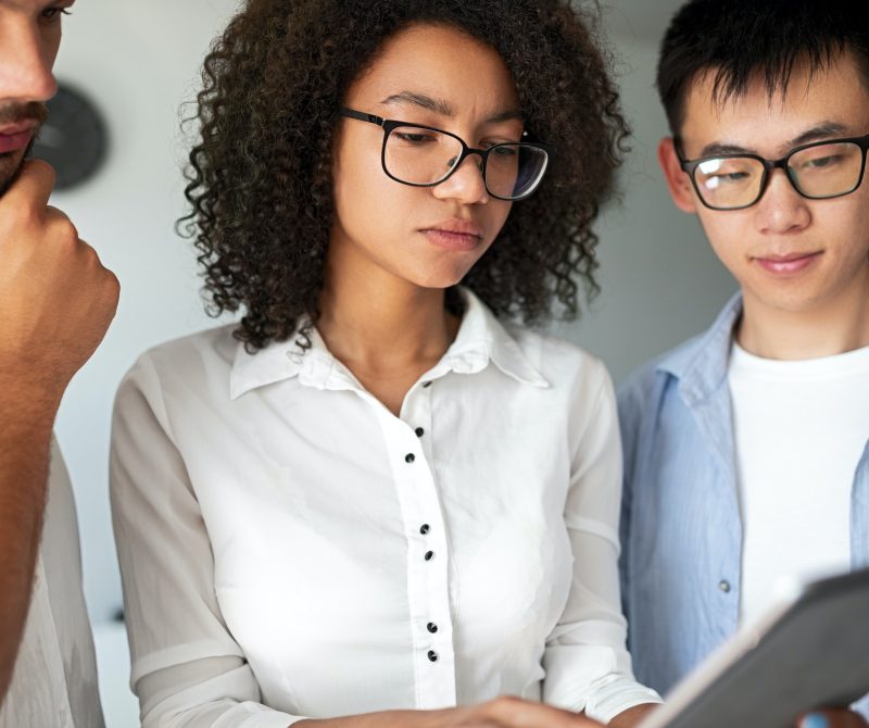 Serious diverse programmers using tablet