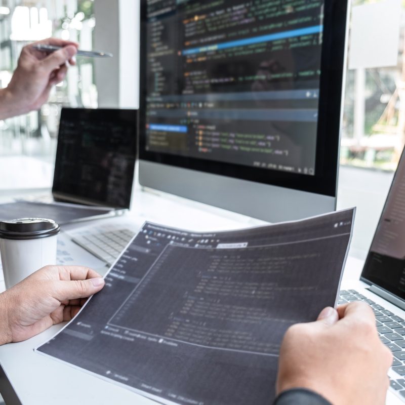 Team of developer programmer working on project in software development computer in IT company