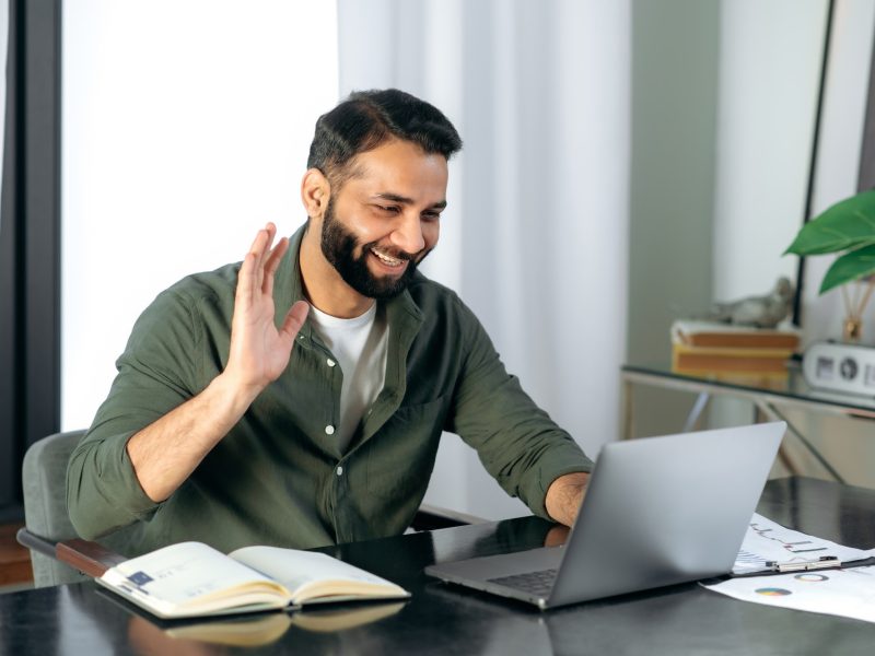 Pleasant friendly indian guy, manager or financial consultant, communicates with colleagues on a