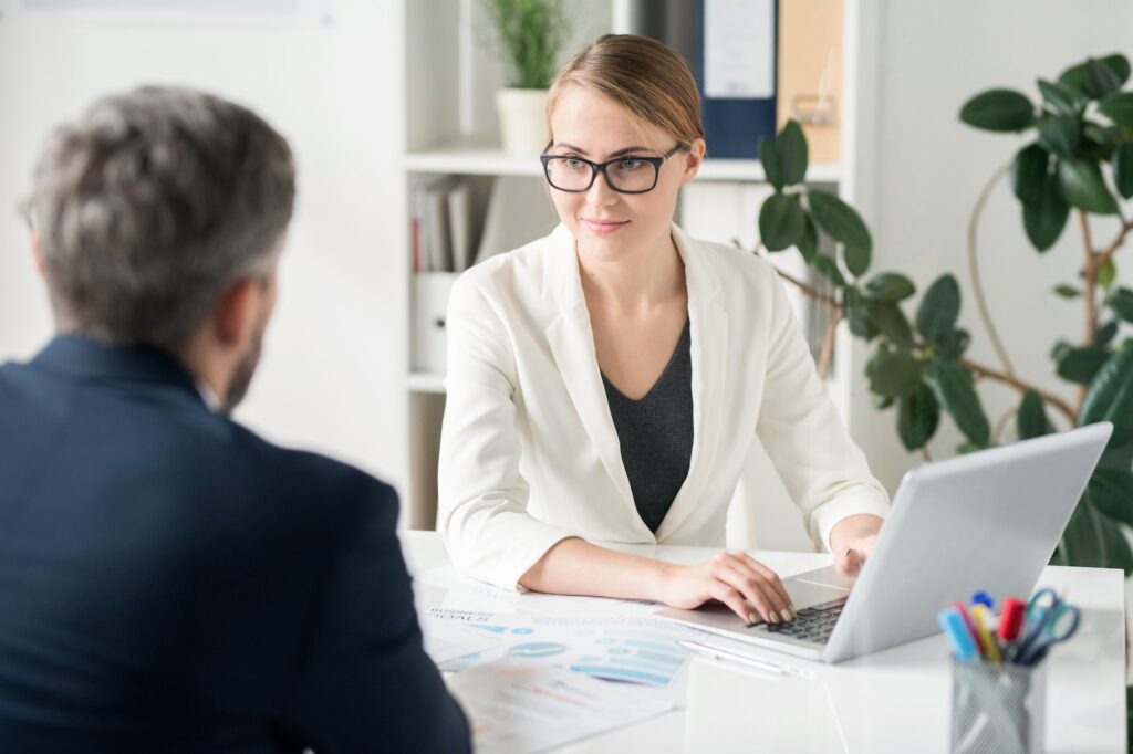 Content attractive female business consultant working with clien