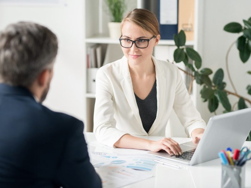 Content attractive female business consultant working with clien