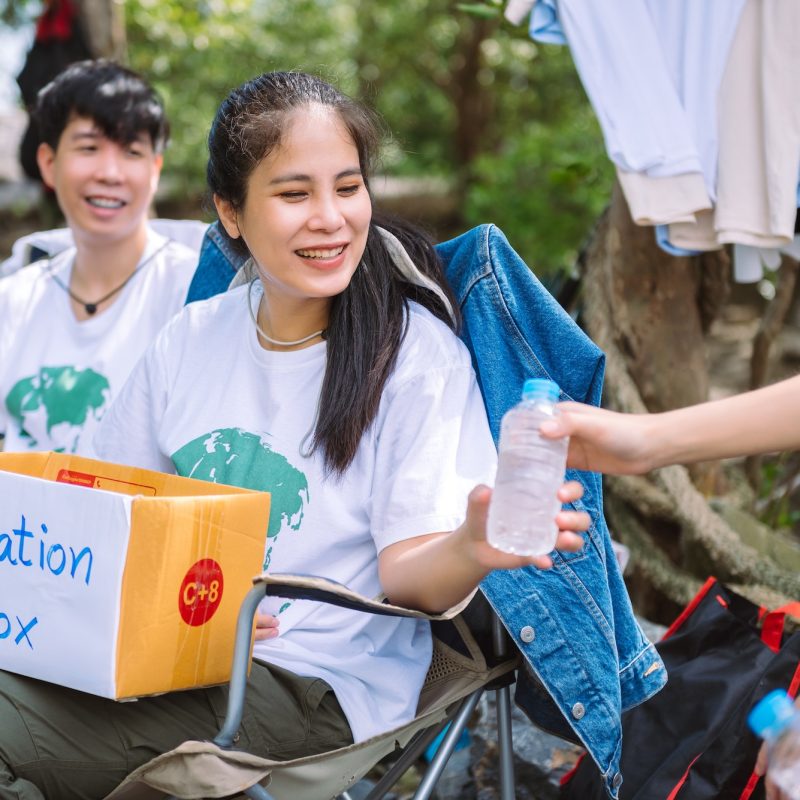 Group of asian diverse people volunteer holding a donation box for fundraiser to emergency situation