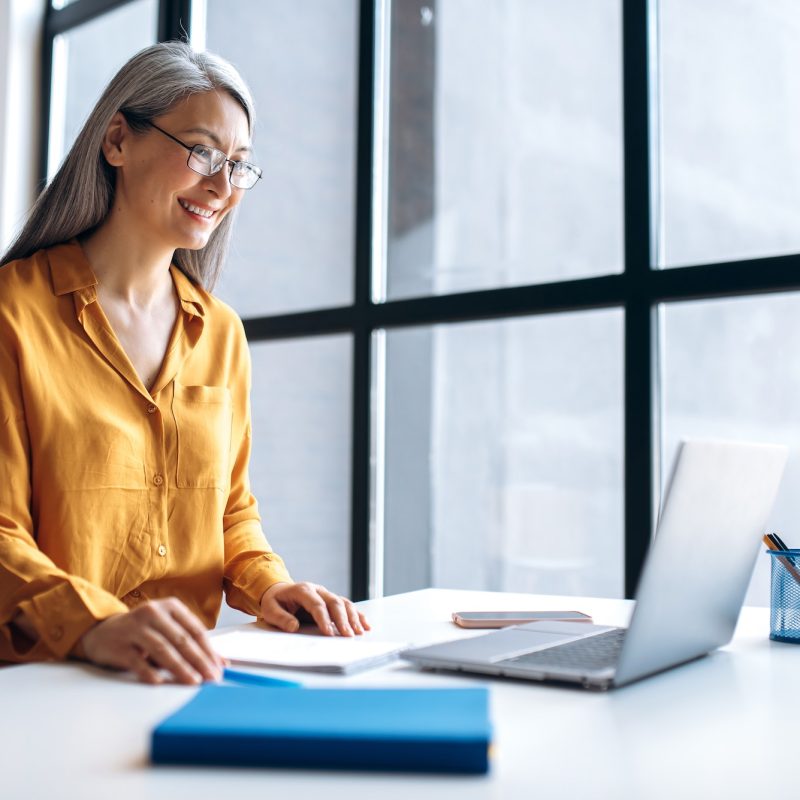 asian woman business online meeting virtual laptop mature