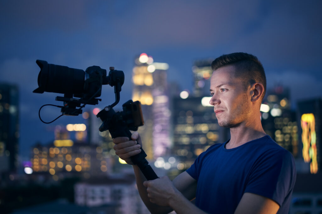 Portrait of videographer with camera and gimbal
