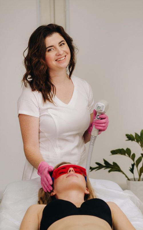 A doctor does laser hair removal for a client of unwanted facial hair in a beauty salon