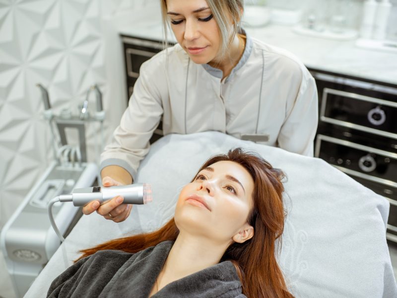 Cosmetologist making facial treatment to a woman