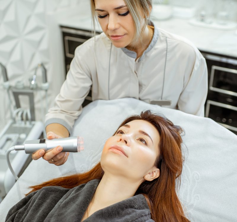 Cosmetologist making facial treatment to a woman