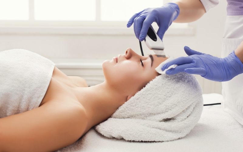 Woman getting facial treatment at beauty salon